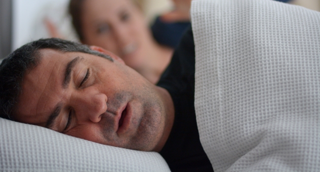 Man snoring in need of sleep apnea treatment