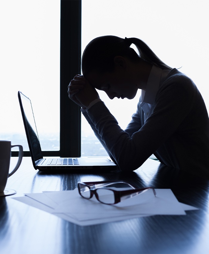 Tired woman at work who needs sleep apnea treatment