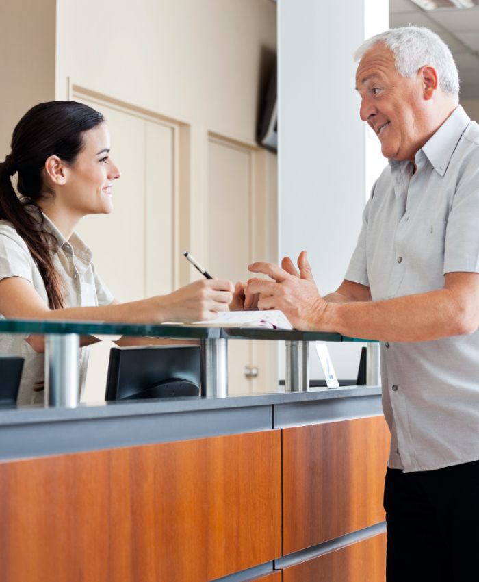 Man discussing insurance coverage for sleep apnea therapy with team member