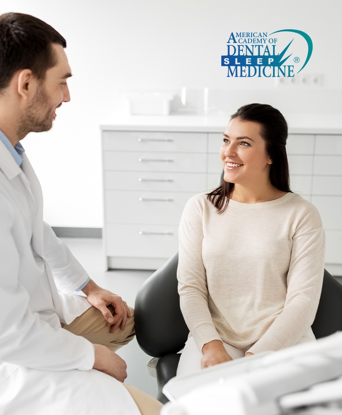 Woman in dental chair smiling at dentist