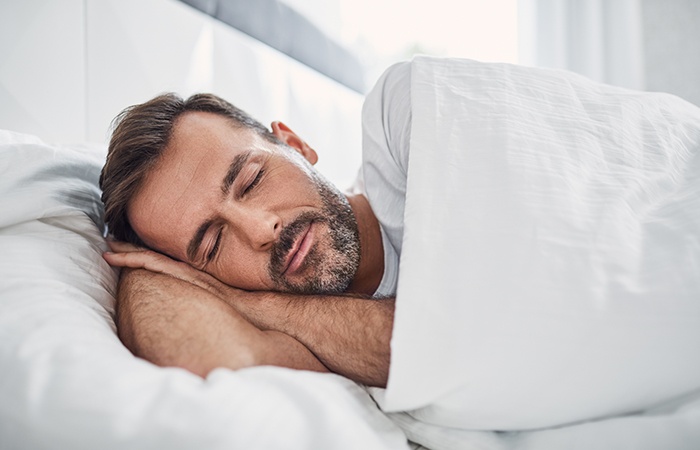 Man sleeping soundly thanks to sleep apnea therapy