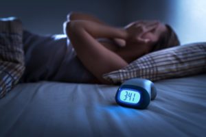 woman struggling with sleep apnea during the holidays