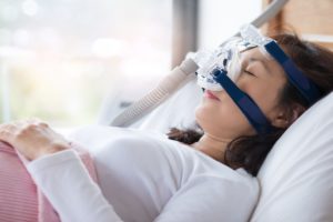 Sleeping woman using a CPAP machine