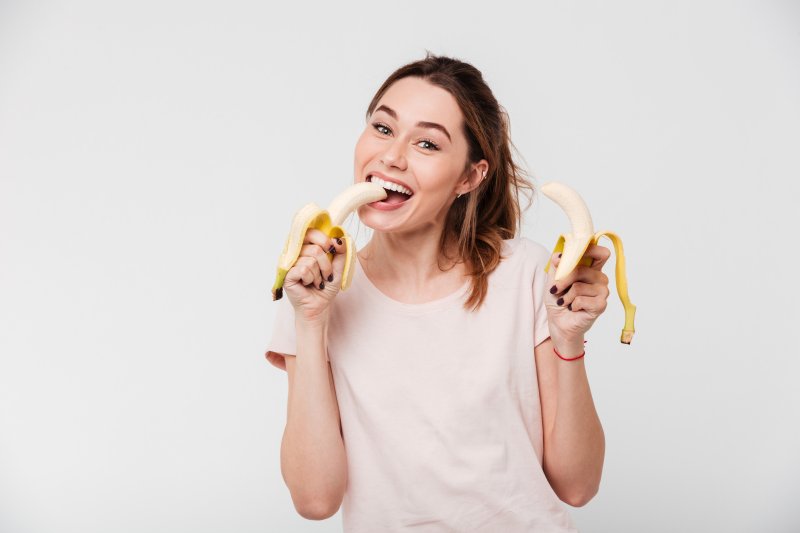 young woman eating banana