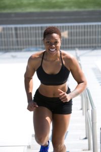 Woman running up bleachers
